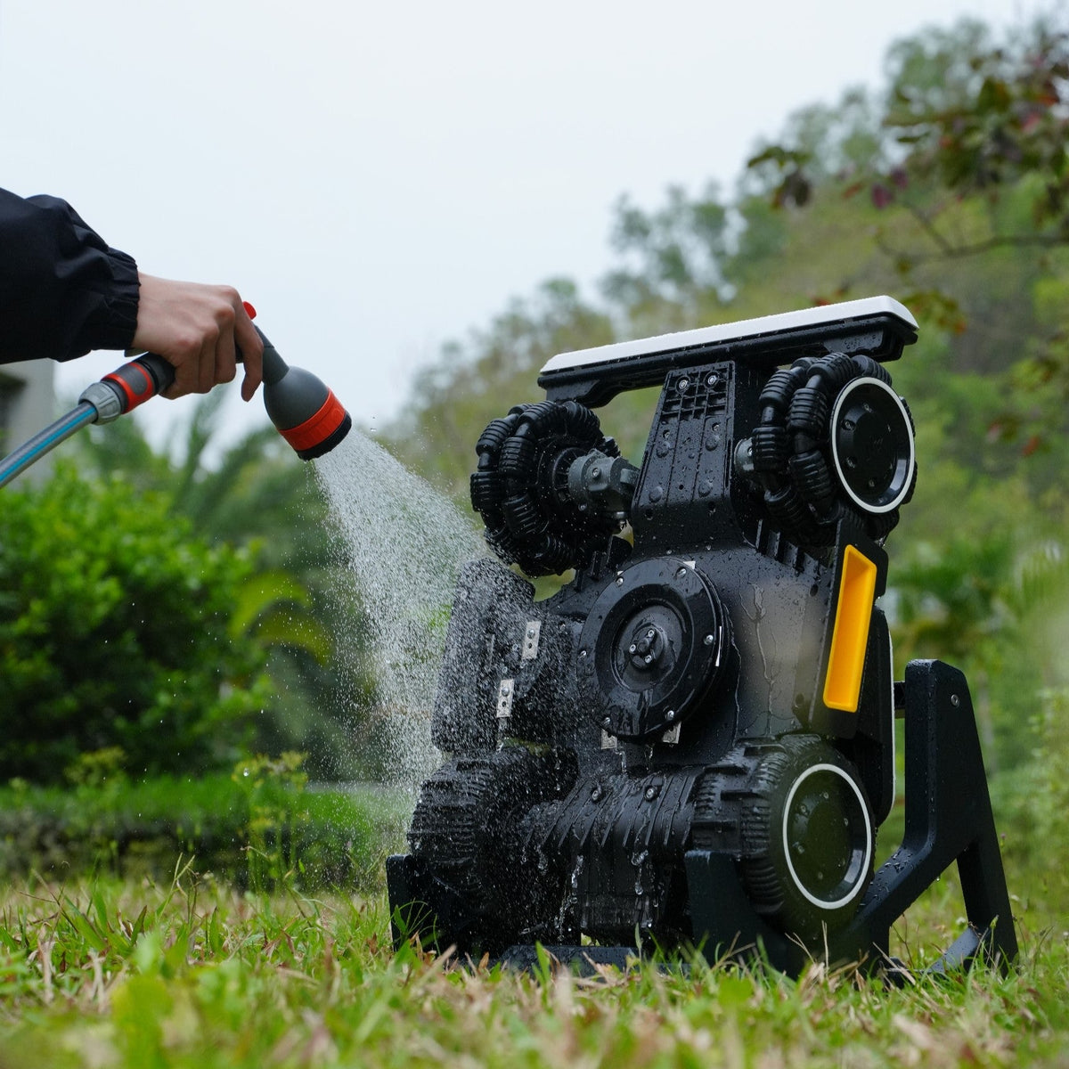 Robot mower raised on the Mammotion cleaning stand for underbody and blade cleaning