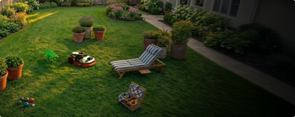 Kress EyePilot robotic mower mowing a family backyard around a sun lounger and garden toys – obstacle avoidance