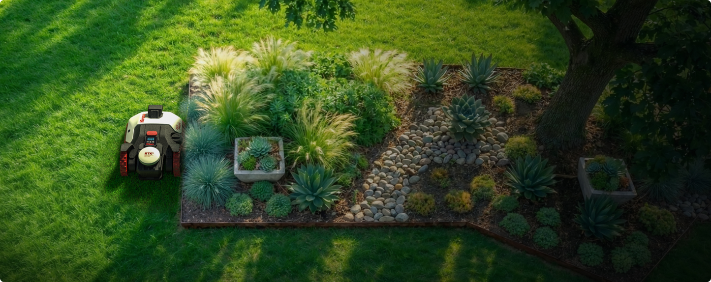 Kress EyePilot robotic mower mowing beside a landscaped garden bed of ornamental grasses and succulents