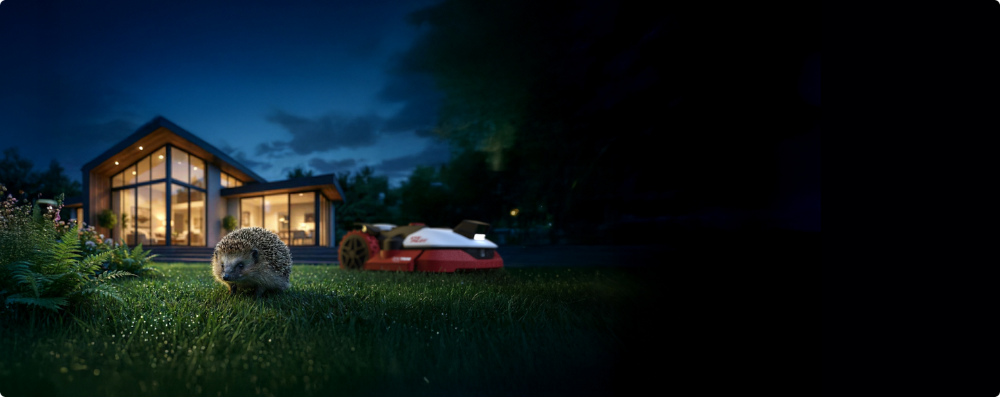 Kress EyePilot robotic mower mowing at night beside a lit home, with a hedgehog on the lawn – vision obstacle detection for wildlife
