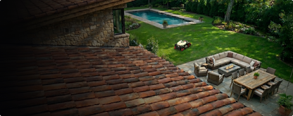 Kress EyePilot 4×4 robotic mower working a landscaped backyard next to a paved patio