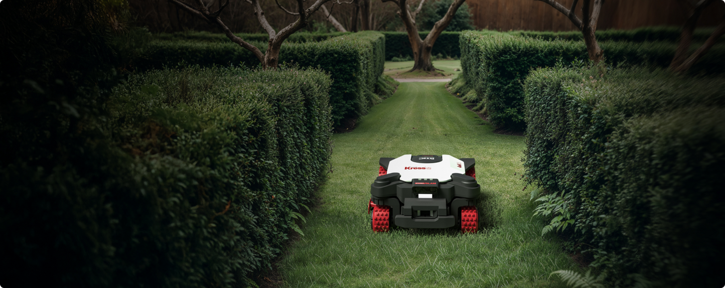 Kress EyePilot 4×4 robotic mower mowing a grass path between tall clipped formal hedges