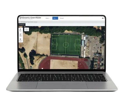 Laptop displaying a drone image of a sports field with a green area.
