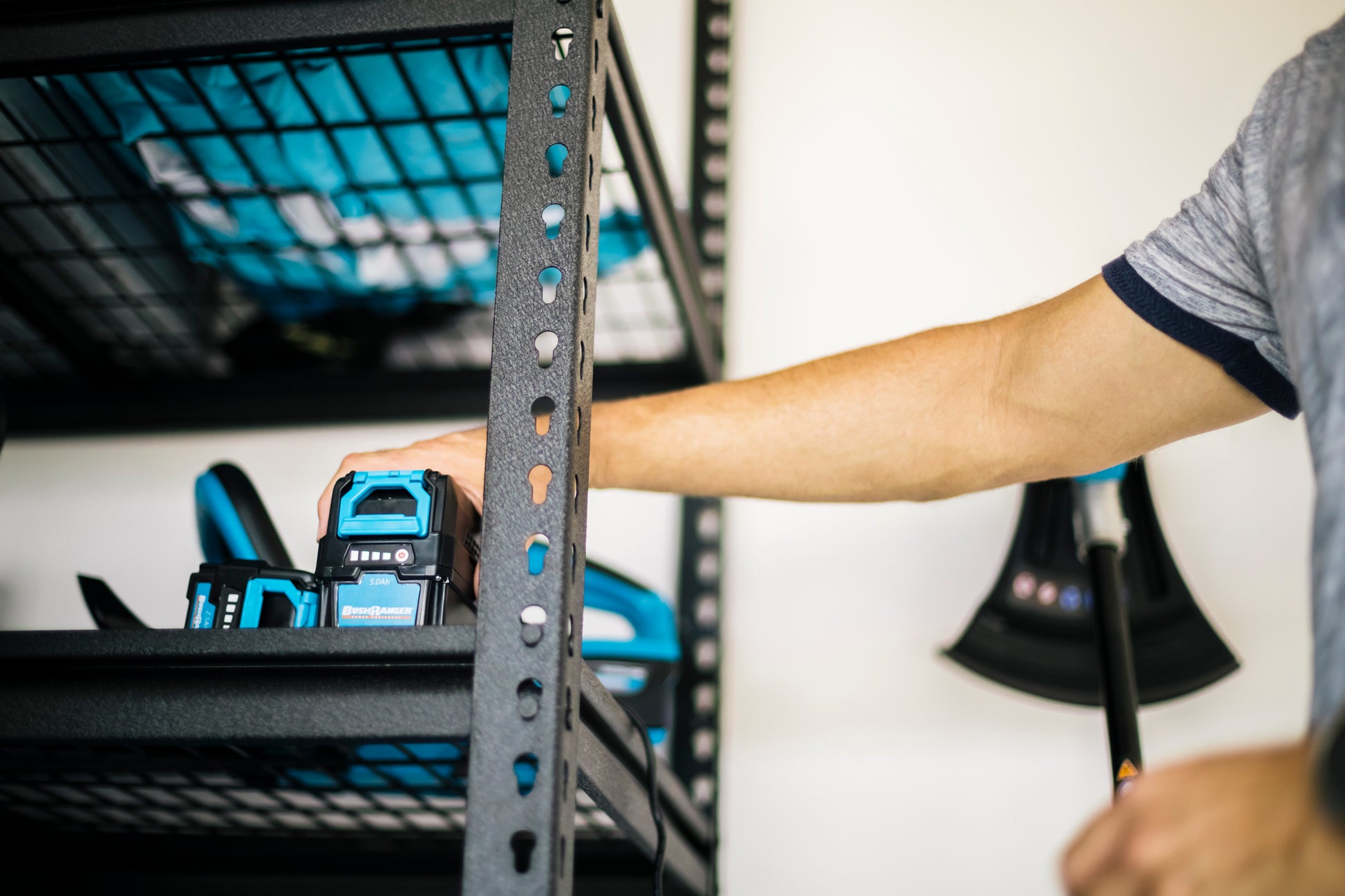 Bushranger® 36V6521 36V Battery Powered Line Trimmer 2.5Ah Kit in garage on shelf