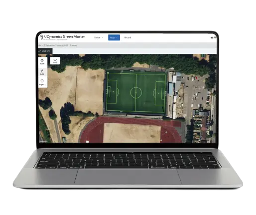 Laptop displaying a drone image of a sports field with a green area.