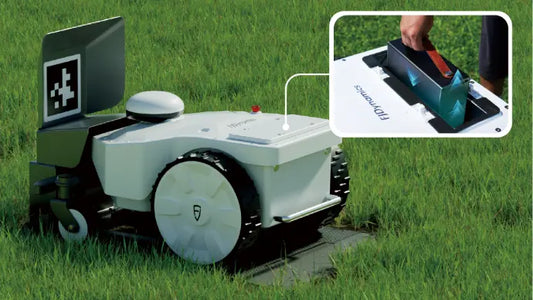 FJD FRX mower in grass with close-up inset of battery compartment