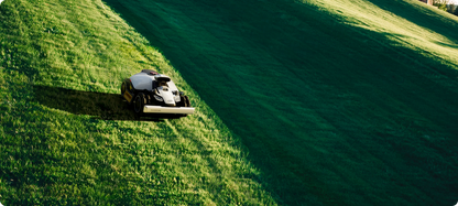 Robotic lawn mower on a grassy field