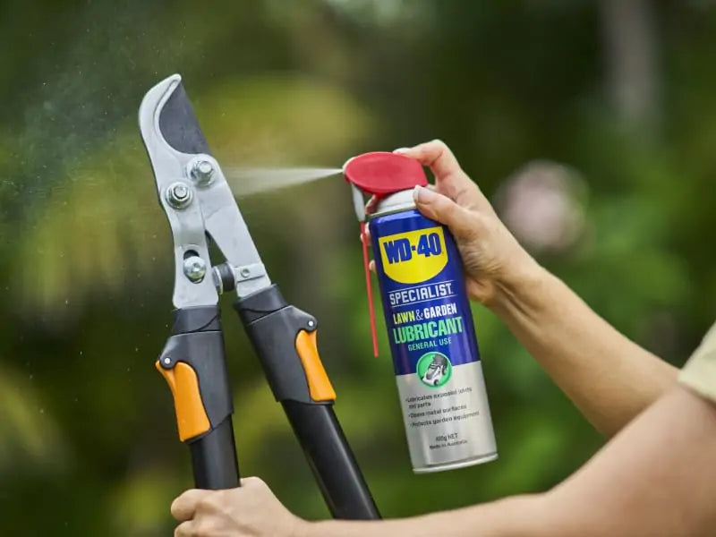 WD-40 Specialist Lawn & Garden Lubricant being sprayed onto garden tool moving parts